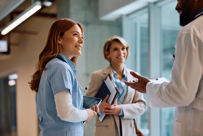 Medical team of doctors and nurses collaborating in a modern clinic corridor